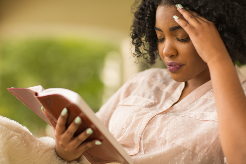 African-American-woman-studying-the-Bible-worried-confused