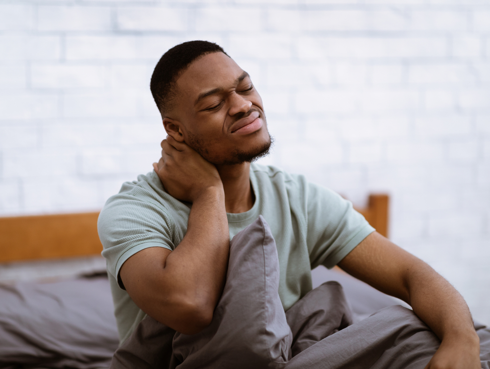 man-waking-up-in-the-morning-with-neck-pain